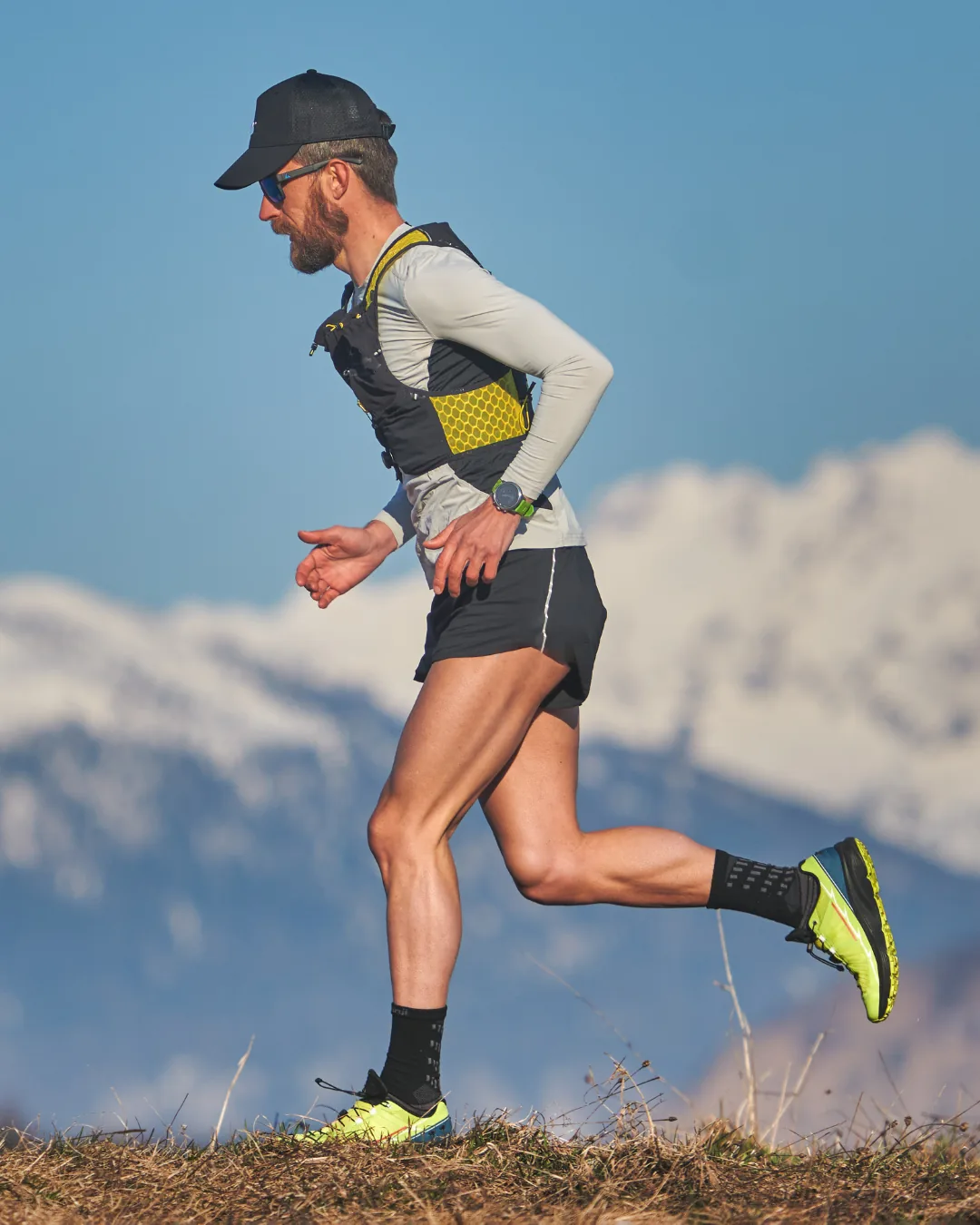 Runner climbing in mountain landscape